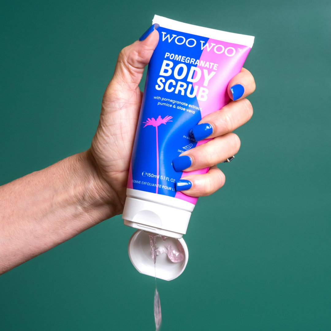 Tube of WooWoo pomegranate body scrub being poured with green background