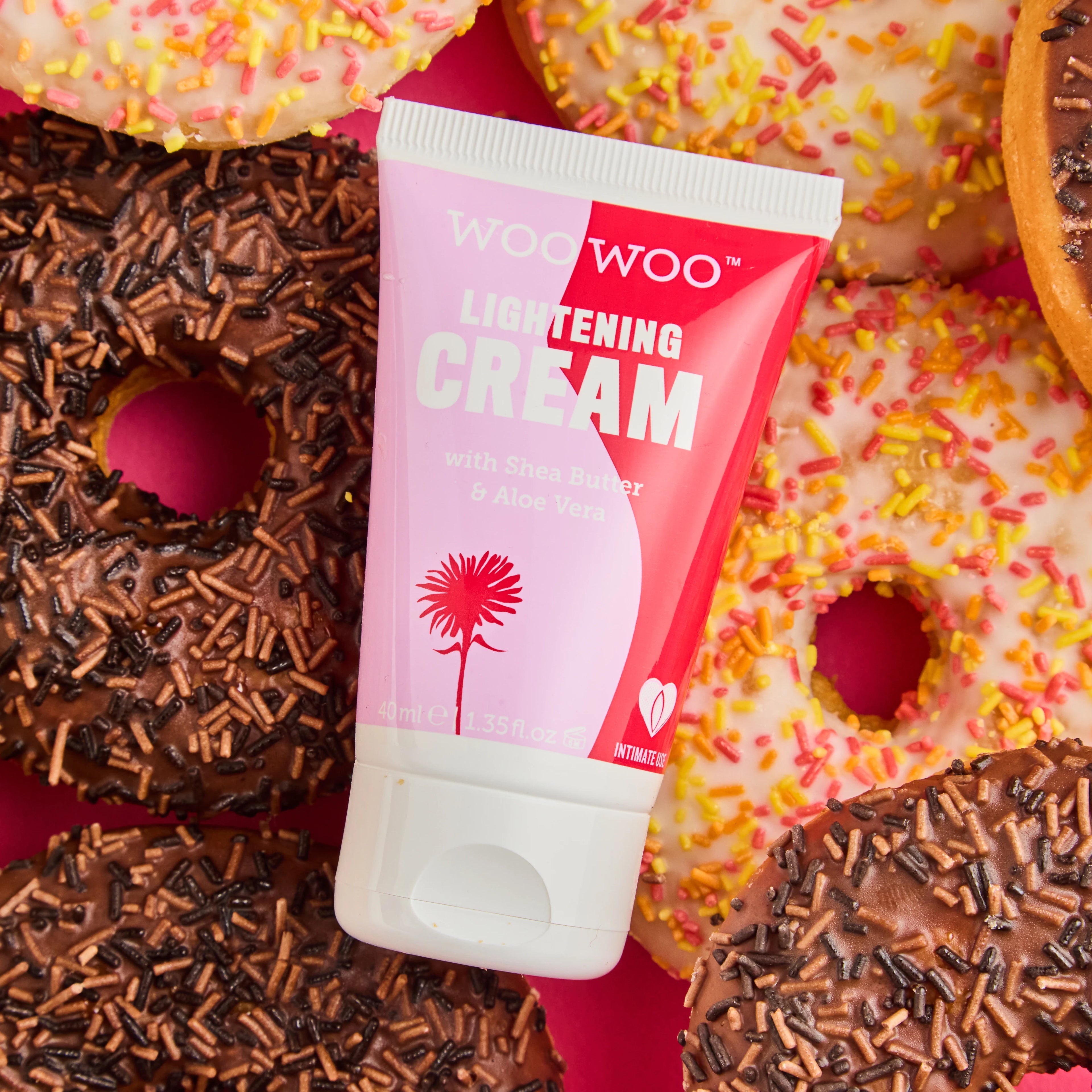 Woo Woo lightening cream tube with colorful donuts in the background