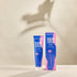 Packaging and tube of Tame It hair removal cream on neutral background