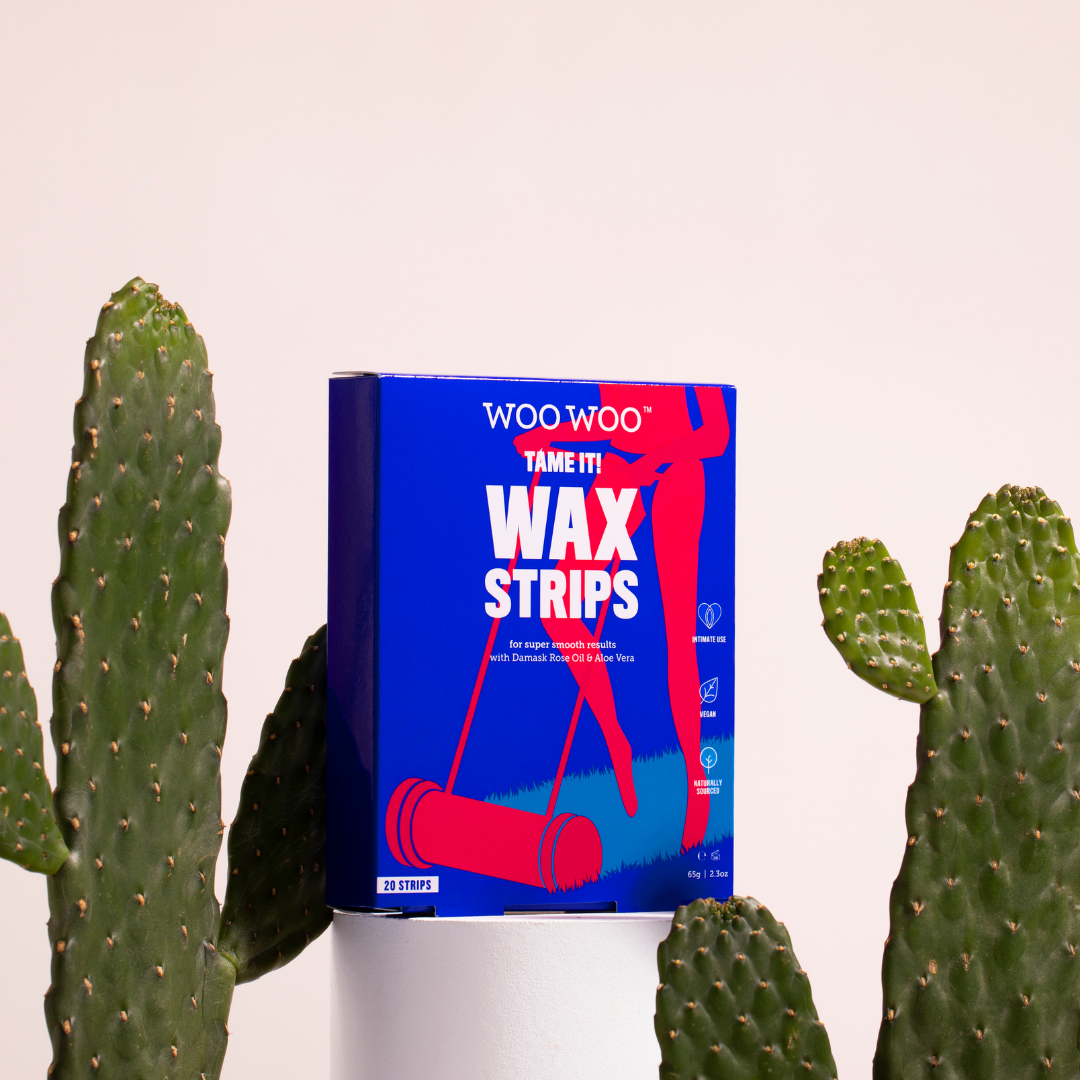 Packet of WooWoo Tame It Wax Strips between cactai and white background