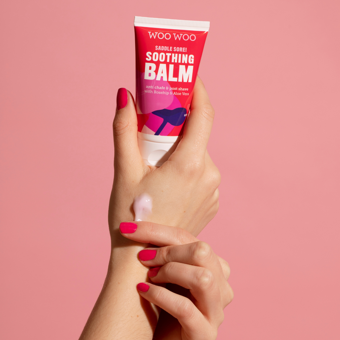 Hands holding a tube of saddle sore soothing balm