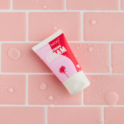 Tube of cream on a pink tiled background