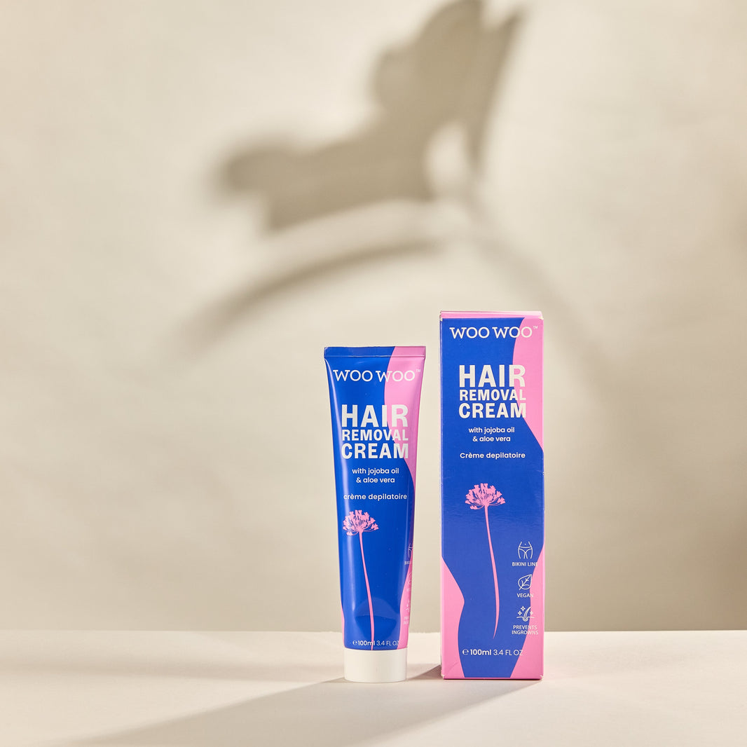 Tube of WooWoo hair removal cream on sand background