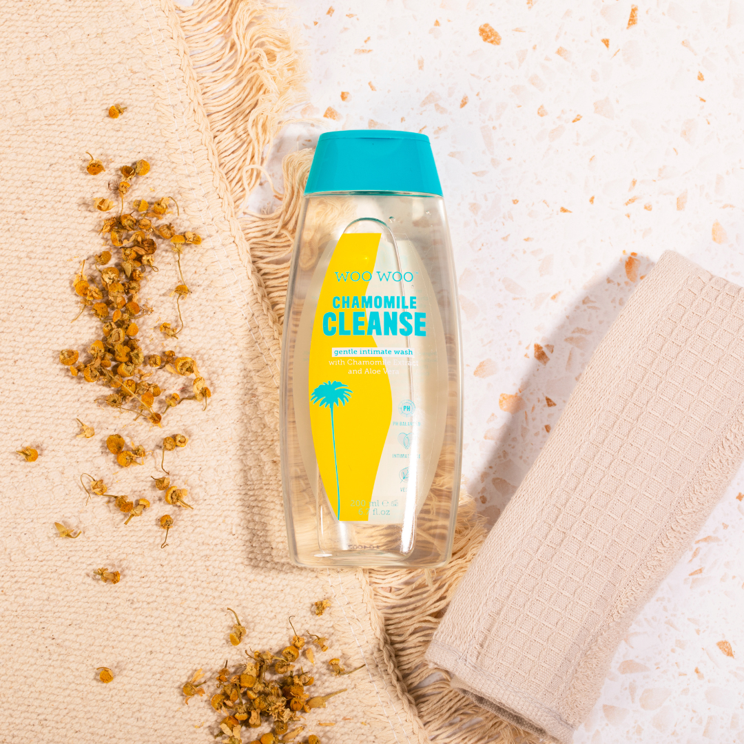 Bottle of WooWoo Chamomile Cleanse on rug and terrazo floor background